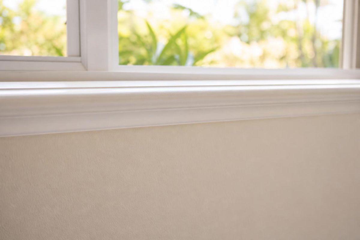 An interior window sill and the wall below it
