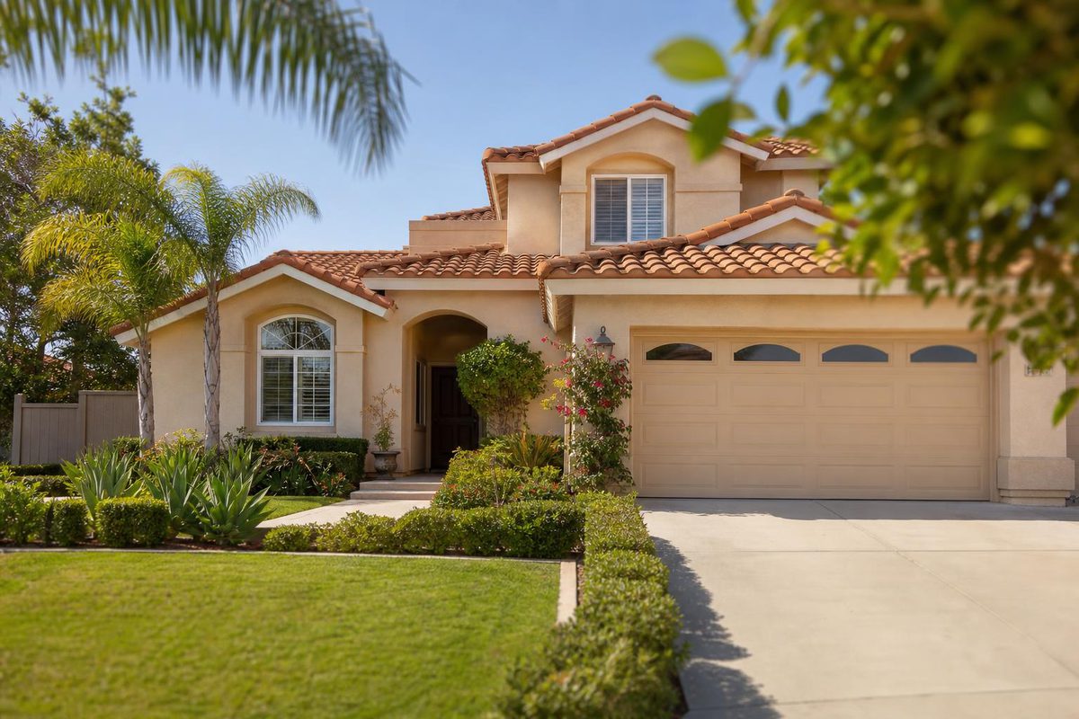 A single-family home in an Orange County suburb, tile roof and tidy front yard